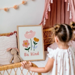 Plakat dla dzieci z kwiatkami i napisem Be Kind w ramce ustawiony w przytulnym pokoju dziewczynki