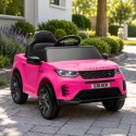 Różowy samochód na akumulator Land Rover Discovery dla dzieci w ogrodzie